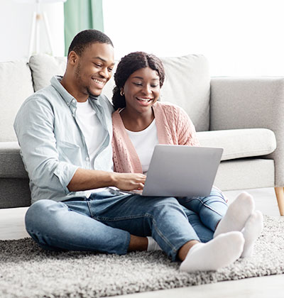 Couple filling out application form on laptop