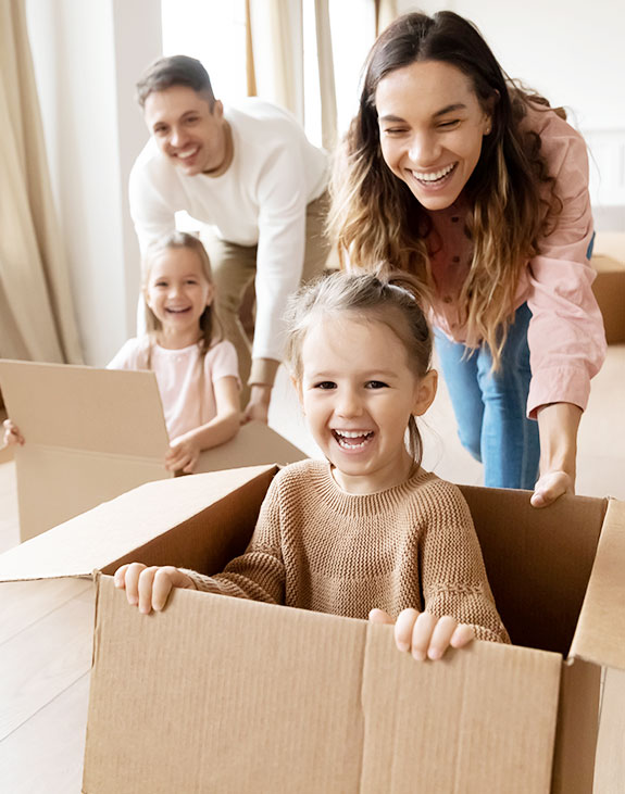 Father and Mother smiling with playing with their children and moving boxes 2